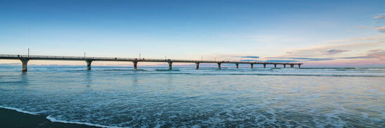 New Brighton Beach with famous New Brighton at Twilight. With 300m (980 feet) length into the south pacific ocean it's the longest pier of AustralAsia and a new icon of Christchurch after the 2011 earthquake destroyed Christchurch's Cathedral, the old city symbol. New Brighton Beach, New Brighton, Christchurch, South Island, New Zealand, Oceania.